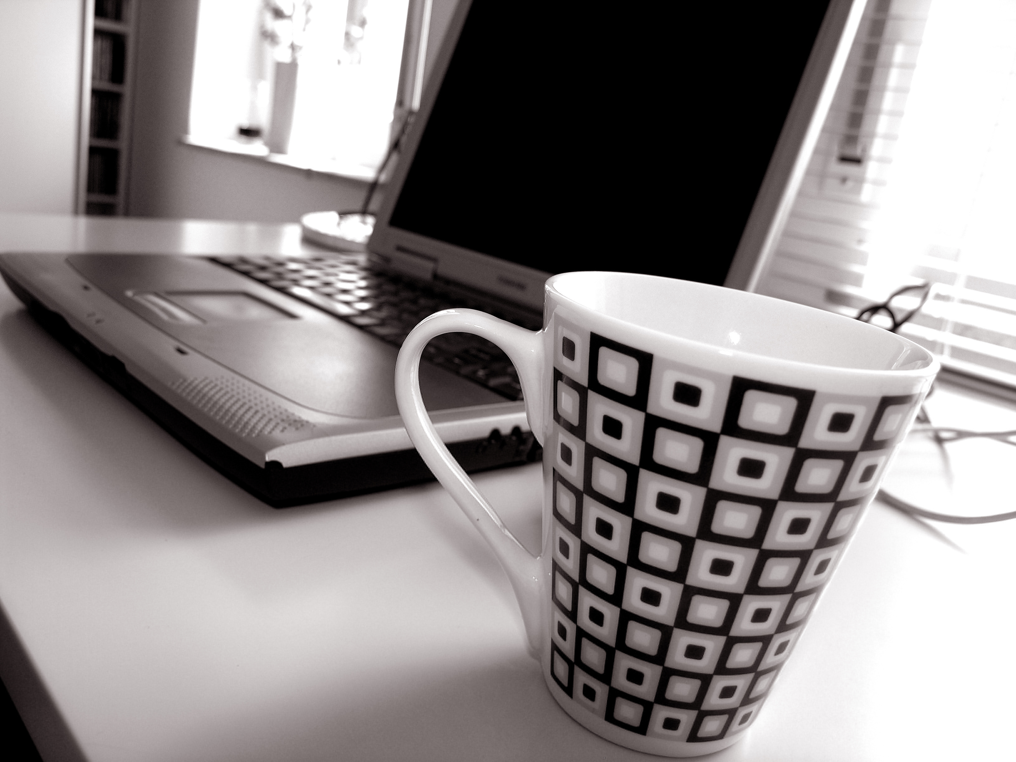 Laptop and coffee mug photo