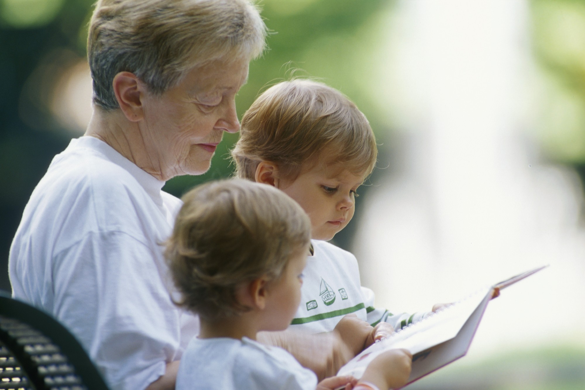 elderly woman reading to children