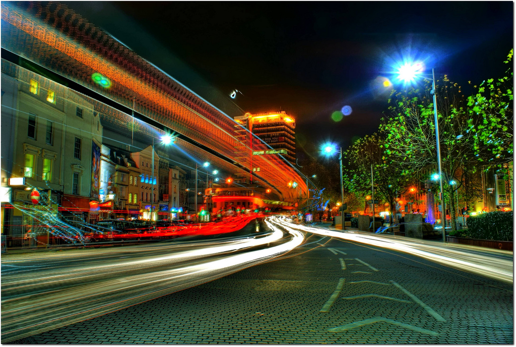 The city of Bristol at night, with exaggerated streaks of multi-coloured light